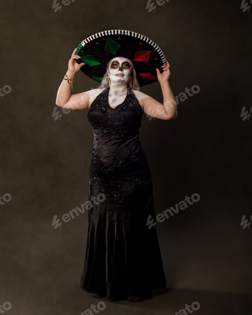 Preview: Portrait of a woman in catrina makeup wearing a charro hat. Sugar skull make up.