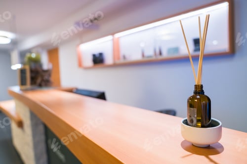 Preview: Selective focus shot of reed diffuser sticks on a bottle on the front desk of a spa