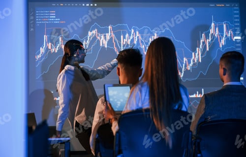 Preview: Showing the plan on the projector. Female leader talking to employees in office