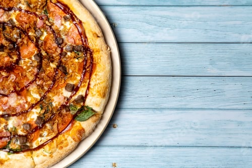 Preview: Delicious large pizza with bacon and spinach on a blue wooden background