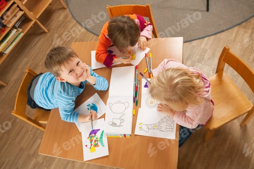 Preview: Germany, Children in nursery sitting at table drawing pictures, elevated view