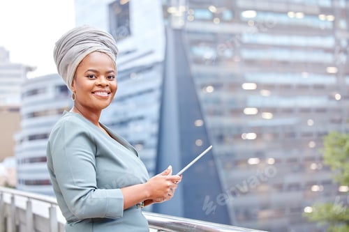 Preview: Shot of a mature businesswoman using a digital tablet against a city background