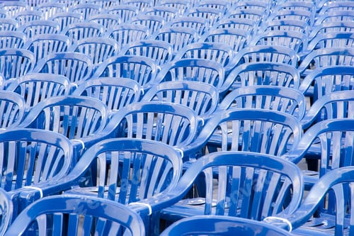 Preview: Many rows of blue pastic chairs