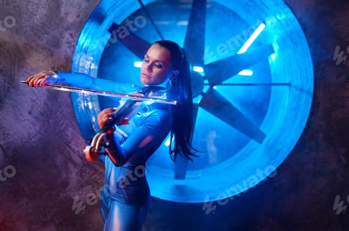 Preview: Artistic woman performer playing violin in atmospheric studio