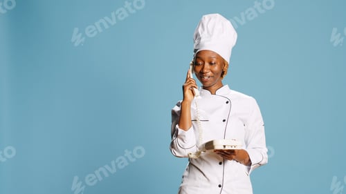Preview: Young gourmet chef using retro landline phone to call