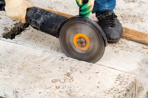 Preview: Close up worker cuts concrete with circular saw