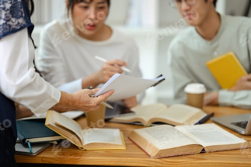 Preview: Cropped shot lecturer answering to university students in classroom. Education concept