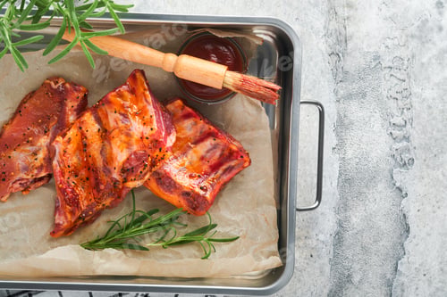 Preview: Pork ribs. Raw meat. Raw pork ribs in marinade with spices, rosemary, tomato sauce and garlic on old