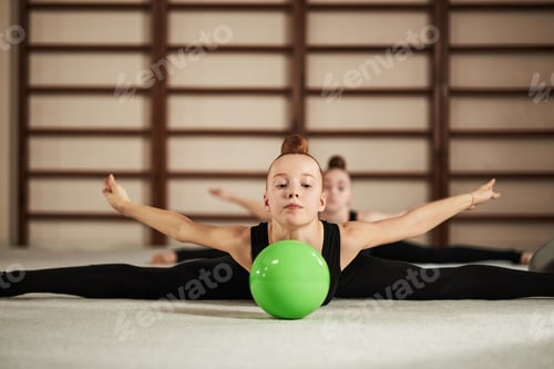 Preview: Portrait of Caucasian Girl Practicing Gymnastics Stretching with Ball