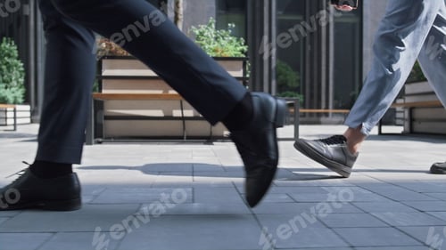 Preview: Closeup corporate people legs walking downtown on sunny day. City lifestyle.