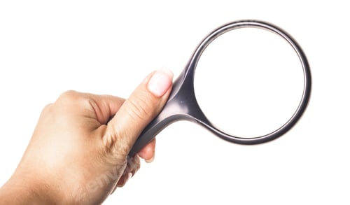 Preview: Hand holding a magnifying glass with a white background, used for inspection or reading