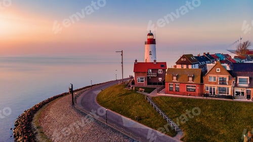 Preview: Urk Flevoland Netherlands sunset at the lighthouse and harbor of Urk Holland. Fishing village Urk