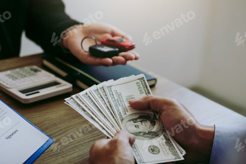 Preview: New car buyers are holding cash and handing it to car salespeople while filing a new car signing