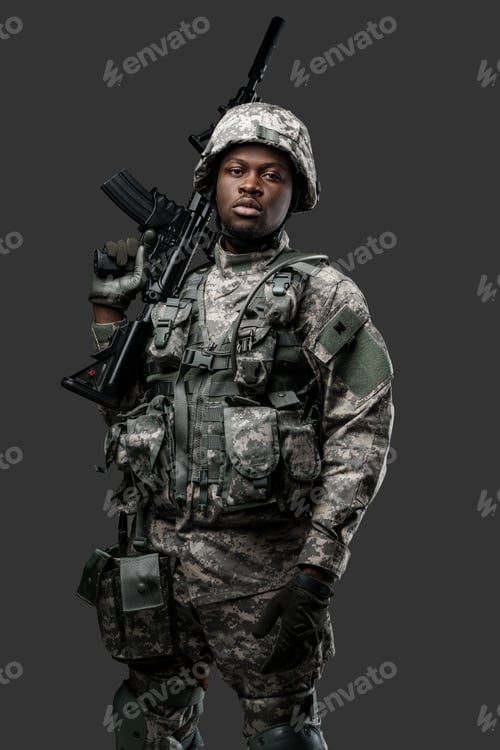 Preview: Armed black soldier with rifle looking at camera