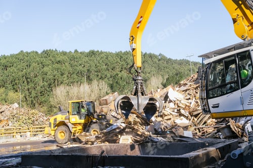Preview: Material handler picking up wooden waste for recycling in a waste treatment plant