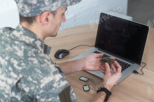 Preview: military man holding a model tank