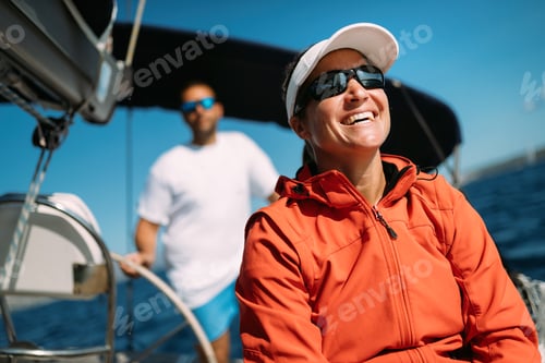 Preview: Attractive strong woman sailing with her boat
