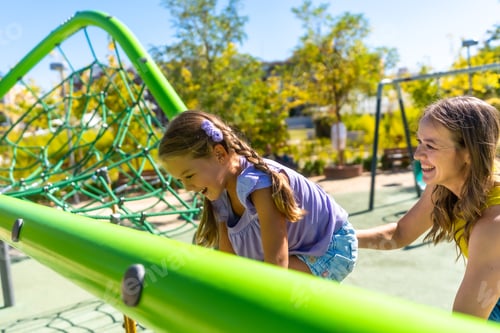 Preview: Mother and daughter playing together at playground
