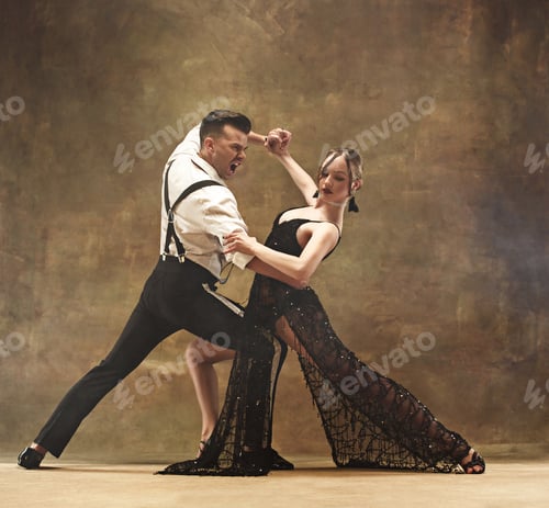 Preview: Flexible young modern dance couple posing in studio.