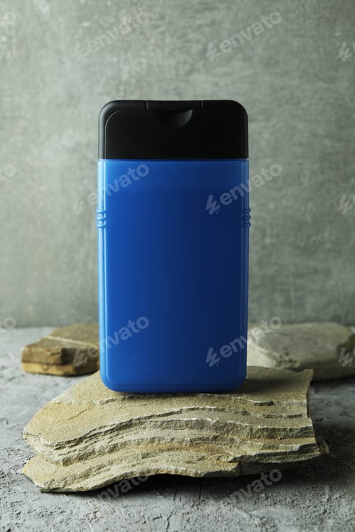 Preview: Bottle of shower gel on stone on gray textured table