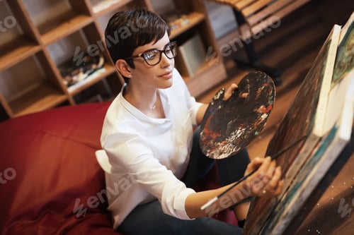 Preview: Creative pensive art school painter working on painting