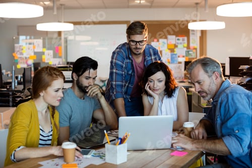 Preview: Creative business team discussing over the laptop