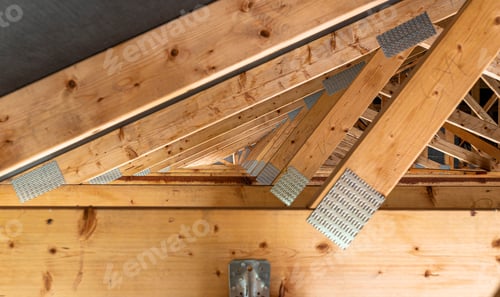 Preview: Roof trusses covered with a membrane on a detached house under construction, view from the inside, v