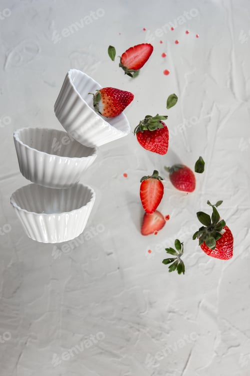 Preview: Red strawberries levitating on a white background. Levitation effect.
