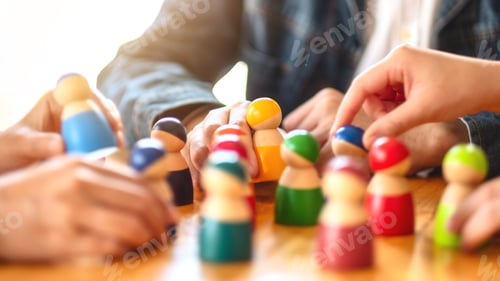 Preview: People choosing and picking up wooden figure from a group on the table