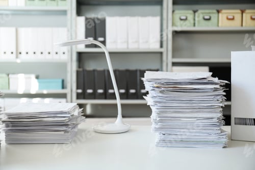 Preview: Stacks of documents on table in office