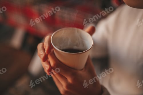 Preview: Portrait of candid authentic dreamer boy teenager enjoying morning cup of hot coffee at home Xmas