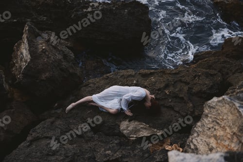 Preview: woman in a white dress lying on a stone in a white dress unaltered