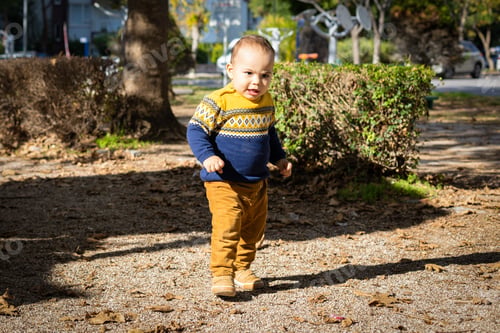 Preview: Funny baby boy playing at outdoors playground. Walking toddler. Fine sunny day
