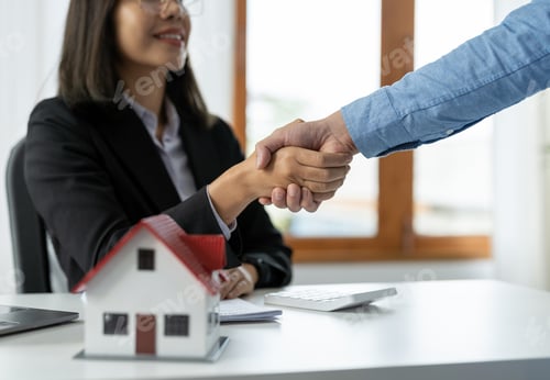 Preview: Real estate agents and customers shake hands to congratulate on signing a contract to buy a house