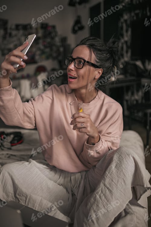 Preview: Woman Takes Selfie While Relaxing on Bed