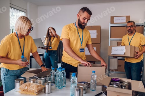 Preview: Group of volunteers working in community charity donation center