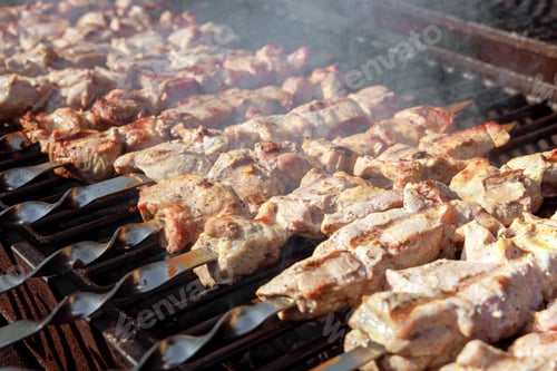 Preview: An outdoor barbecue grill is used to grill pork skewers over a charcoal