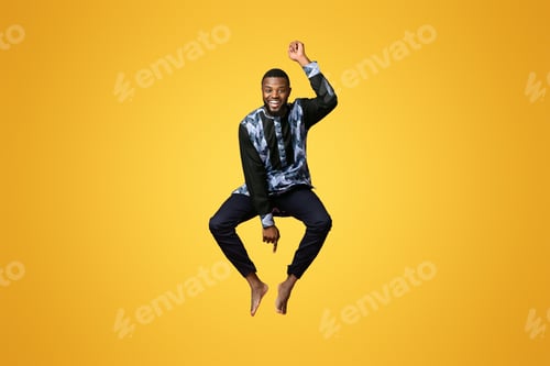 Preview: Funny black man in african costume jumping in the air