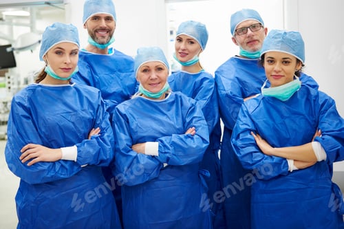 Preview: Team of Surgeons Posing in Operating Room