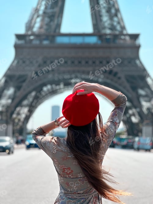 Preview: Young Woman With Long Hair Wearing a Red Beret Standing in Front of Eiffel Tower in Paris