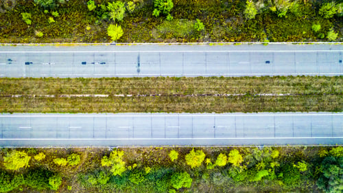 Preview: Empty road across green field