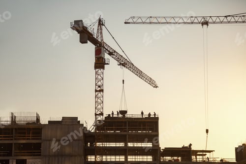 Preview: Construction Activity at a Site With Cranes During Sunset Hours