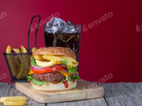 Preview: Fresh juicy beef hamburger with french fries and cola placed on wooden background