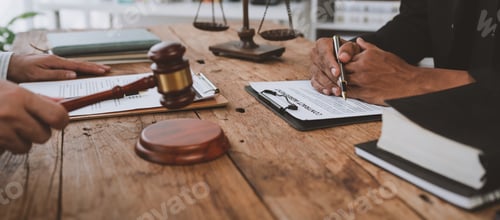 Preview: An attorney or legal advisor is carefully reading the validity of investment documents and signing a