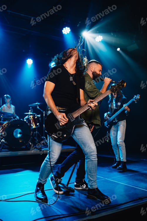 Preview: Rock band performing energetically on stage under blue lights