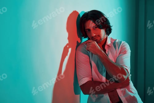 Preview: Portrait of young hot man that stands in neon lights in the studio
