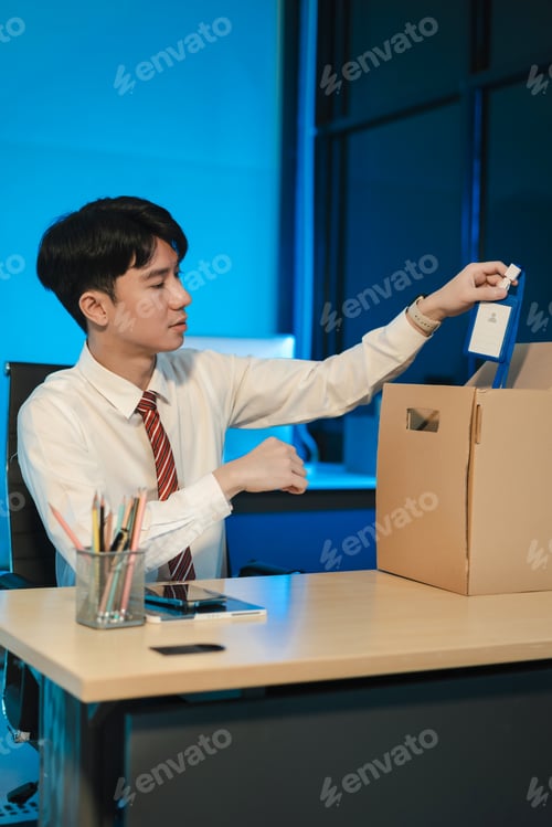 Preview: Concept business failure and unemployment problem, stress businessman packing up in office.