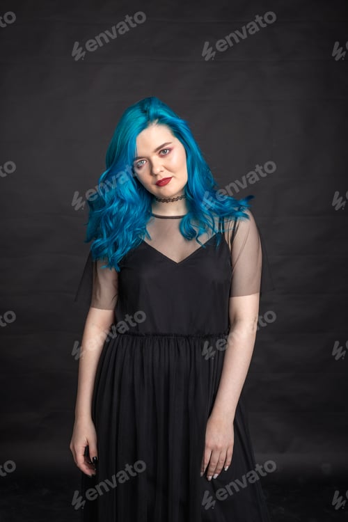 Preview: People and fashion concept - Woman with blue long hair dressed in black dress posing over black