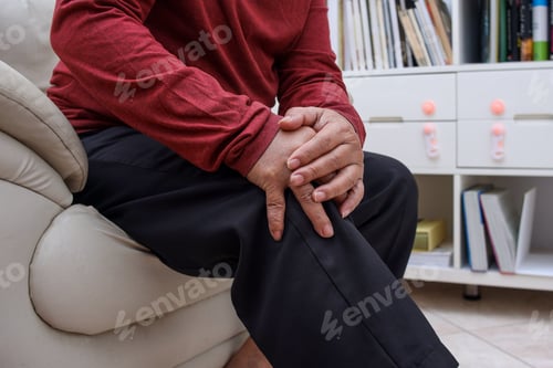 Preview: Close up senior hand having pain on knees