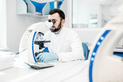 Preview: Medic working with microscope at the laboratory